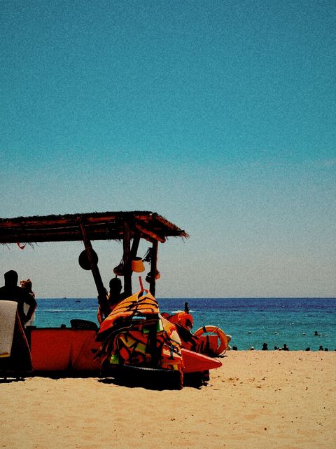 The same beach hut with stronger grain and warmer colour — shot on ELEV ARCADE