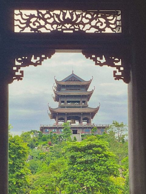 A pagoda framed by a carved wooden gate — shot on A WRX